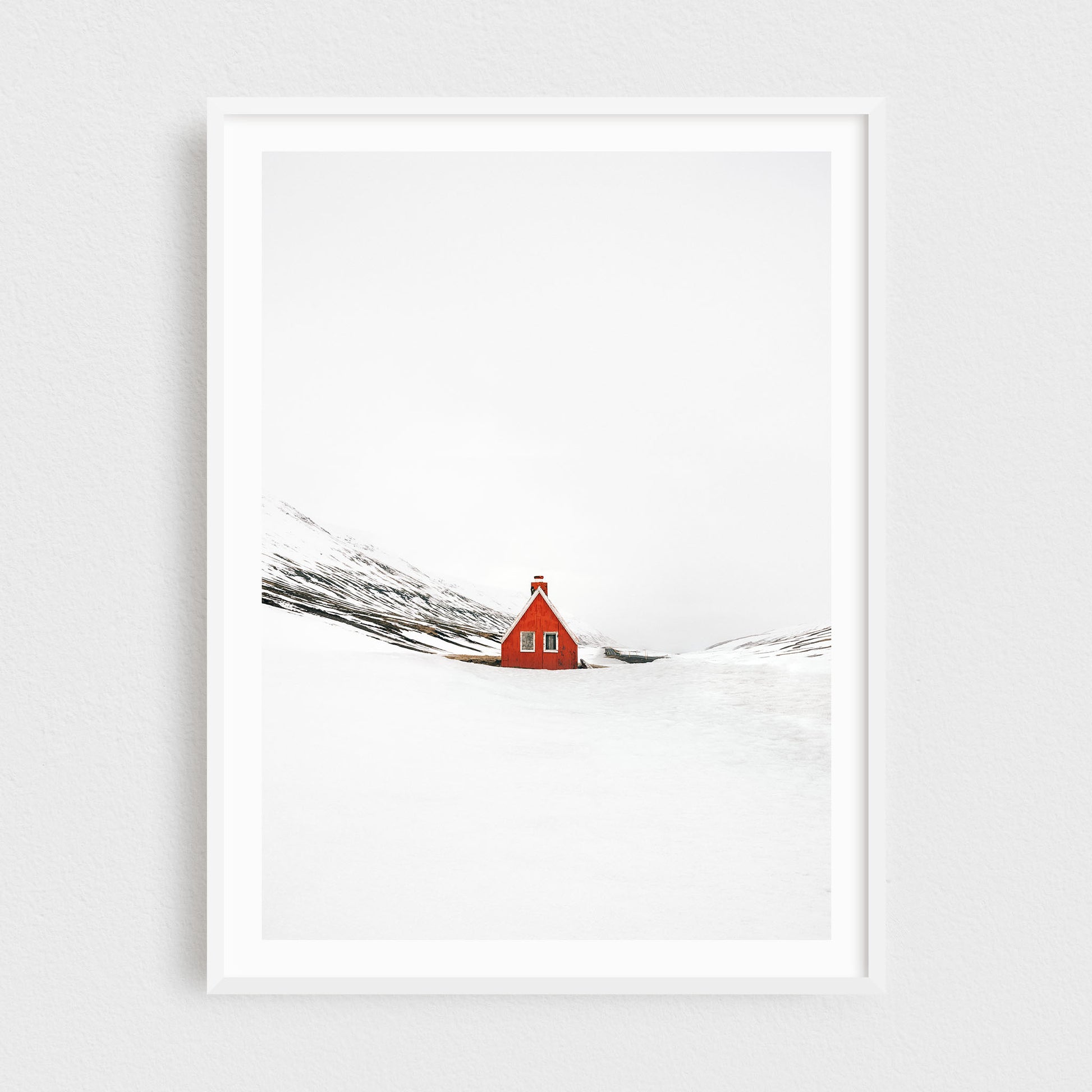 Iceland fine art photography print featuring a red cabin in winter, in a white frame