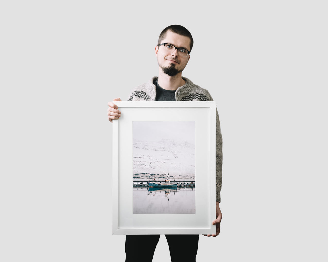 Nordic travel photography print featuring an old blue fishing vessel moored in the fjord of Seydisfjordur in Iceland in winter