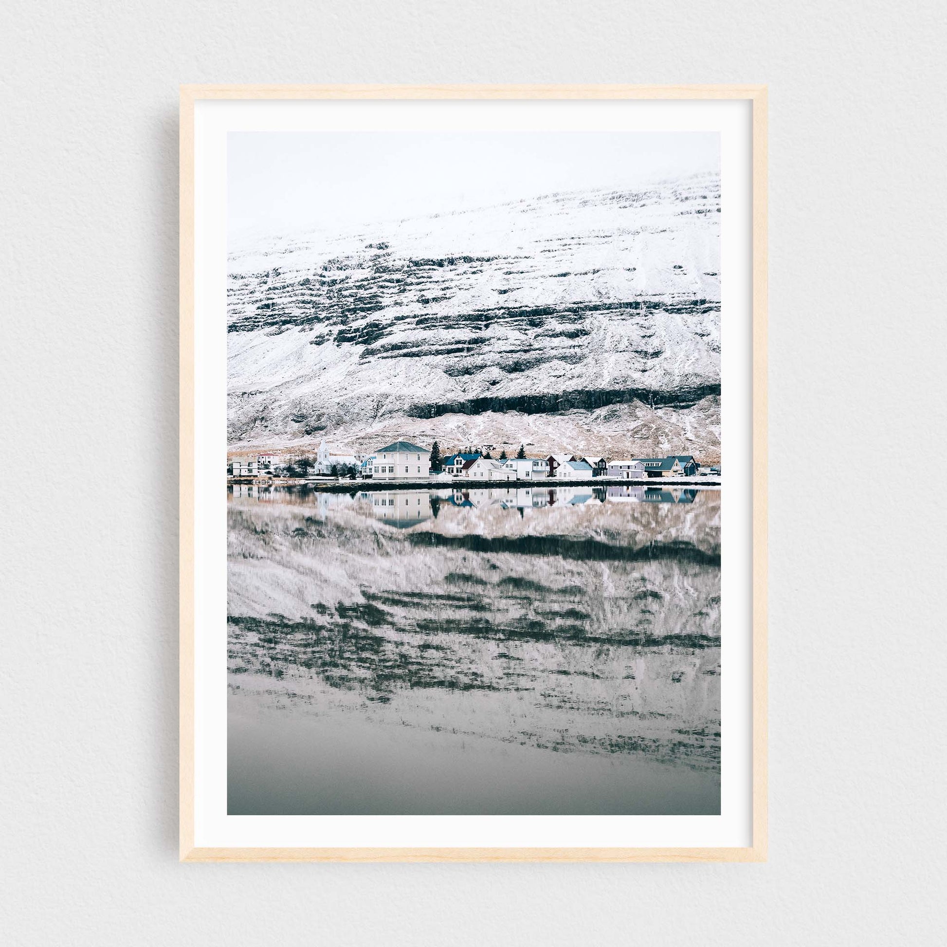 Iceland fine art photography print featuring Seydisfjordur in winter, in a maple frame