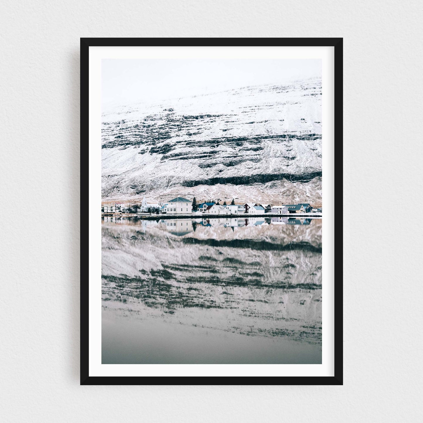 Iceland fine art photography print featuring Seydisfjordur in winter, in a black frame