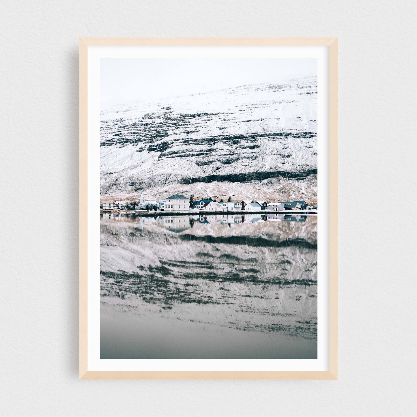 Iceland fine art photography print featuring Seydisfjordur in winter, in a maple frame