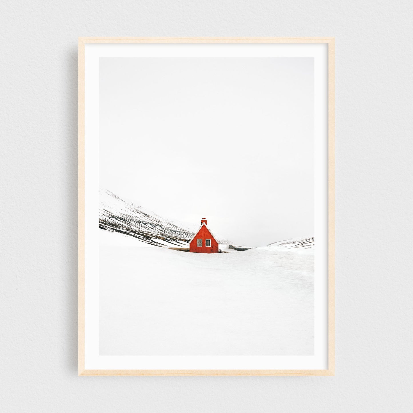 Iceland fine art photography print featuring a red cabin in winter, in a maple frame
