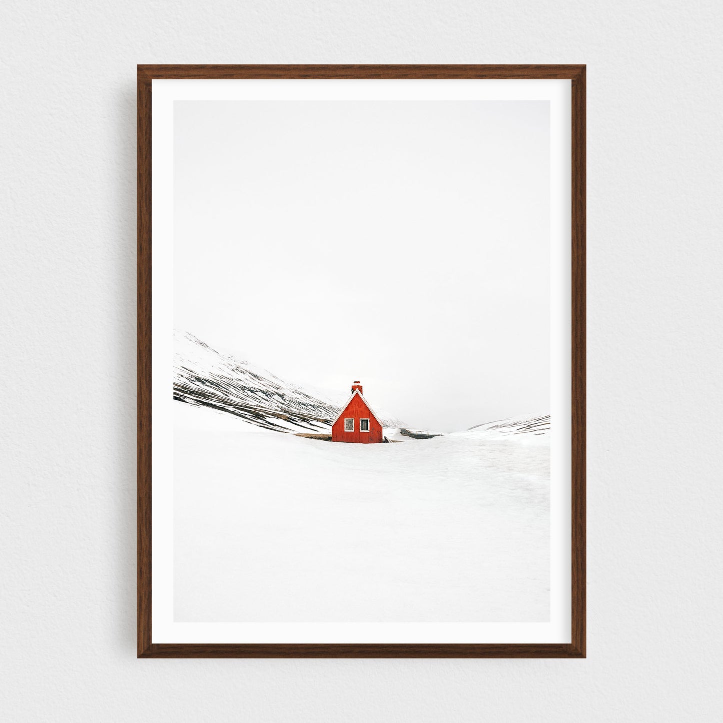 Iceland fine art photography print featuring a red cabin in winter, in a walnut frame