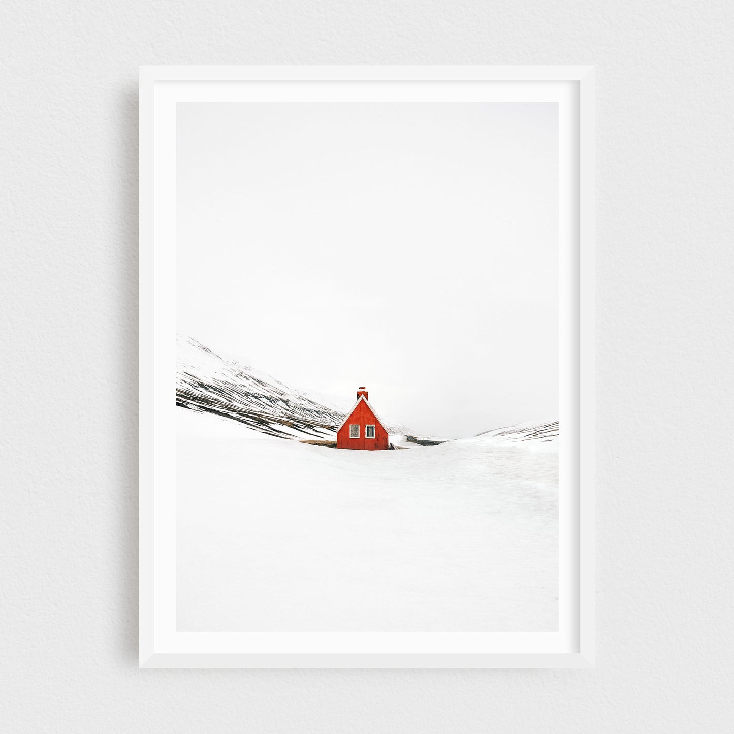 Iceland fine art photography print featuring a red cabin in winter, in a white frame