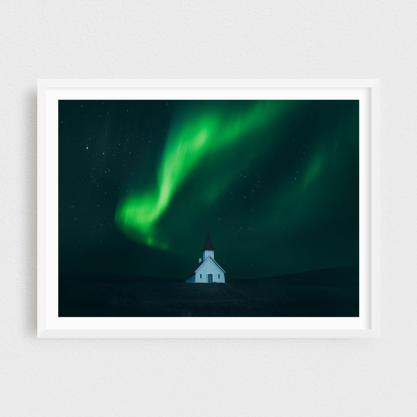 Northern Lights Dancing over the White Church of Breiðavík