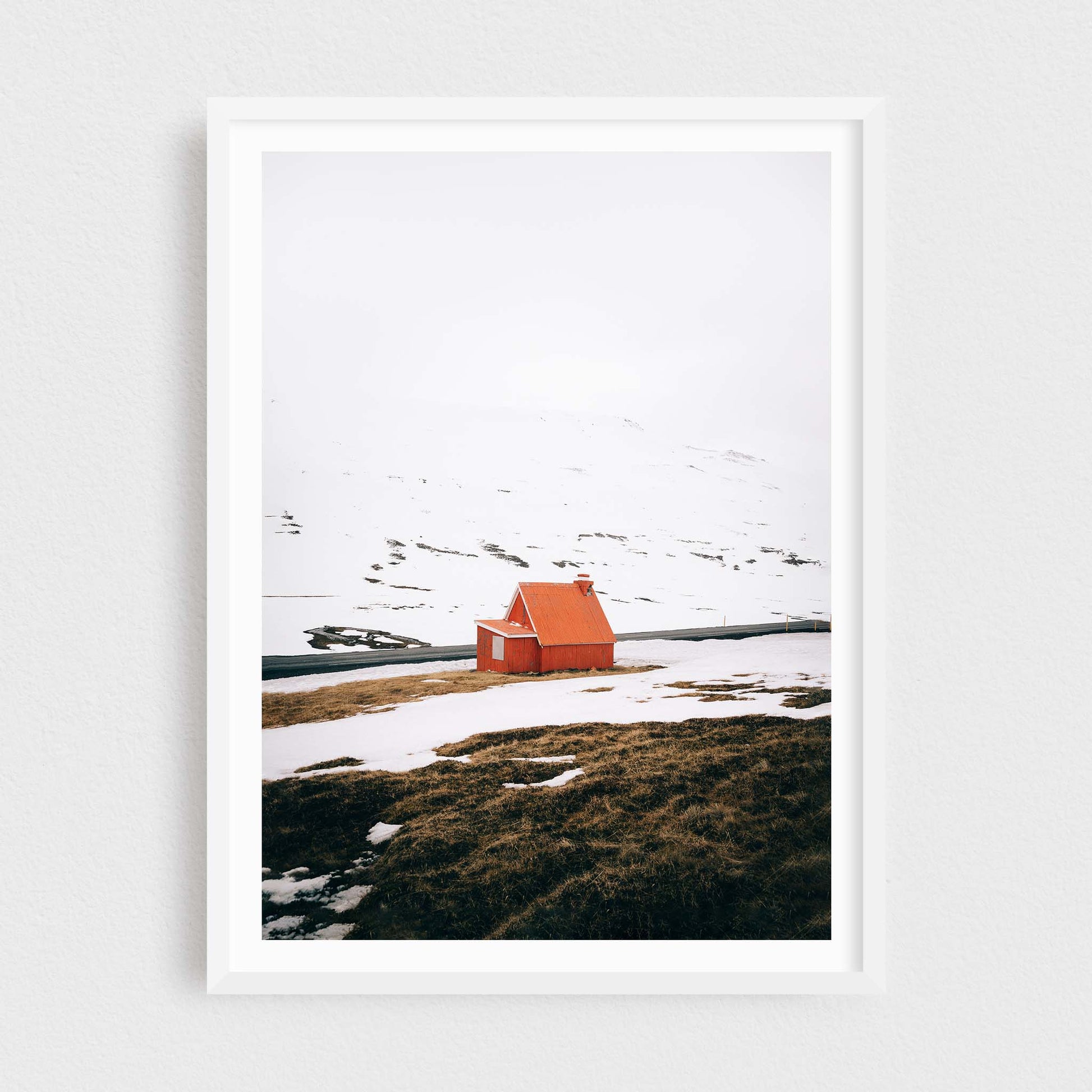 Iceland fine art photography print featuring a red cabin in winter, in a white frame
