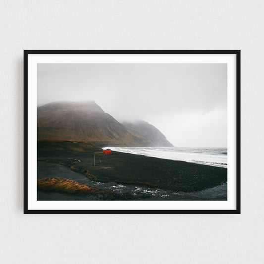 Iceland fine art photography print featuring Westfjords red cabin on a black sand beach
