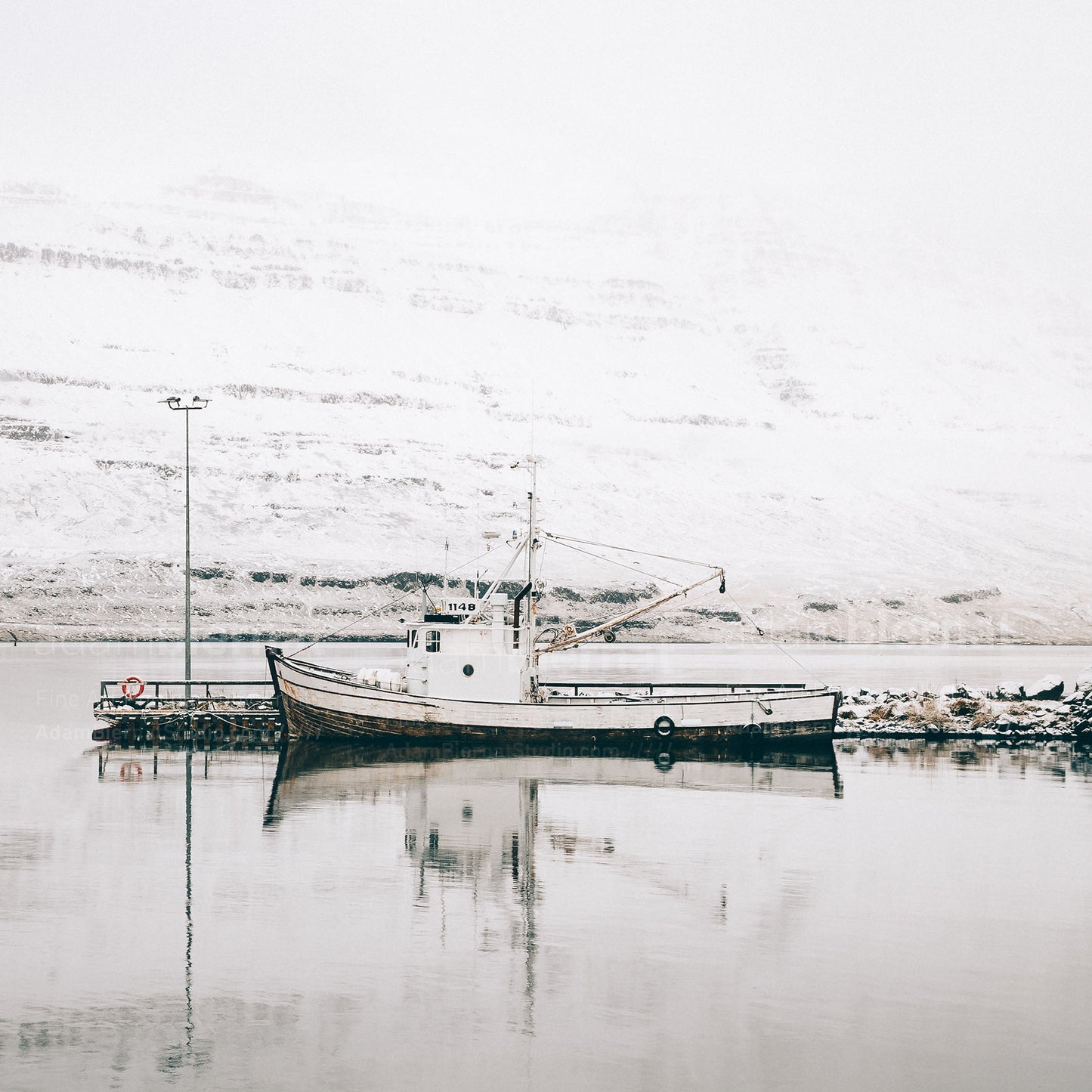 Old wooden fishing vessel in the fjord in Iceland photography print